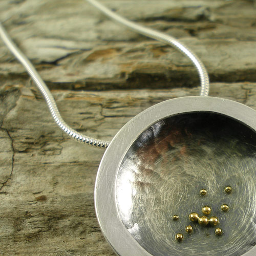 Silver border pendant with gold granules